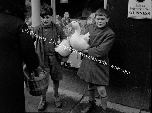 BOY WITH GOOSE AMID SHOPPERS AD FOR GUINNESS